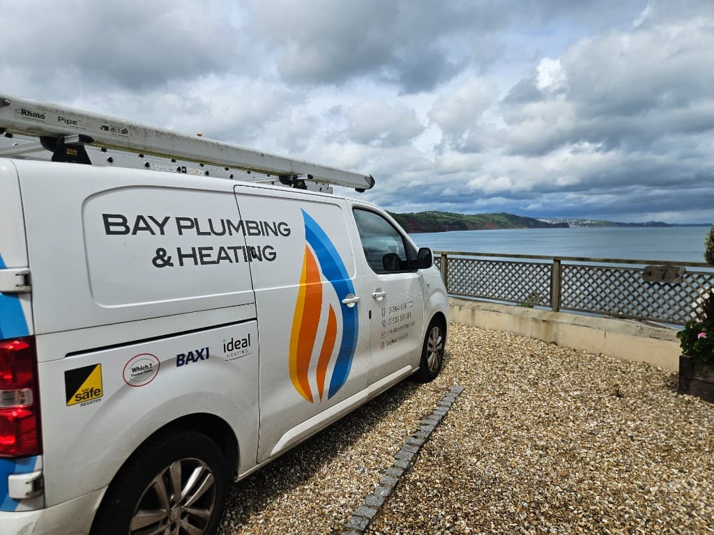 Bay Plumbing & Heating branded van beside the Torbay coastline — local Gas Safe heating engineers