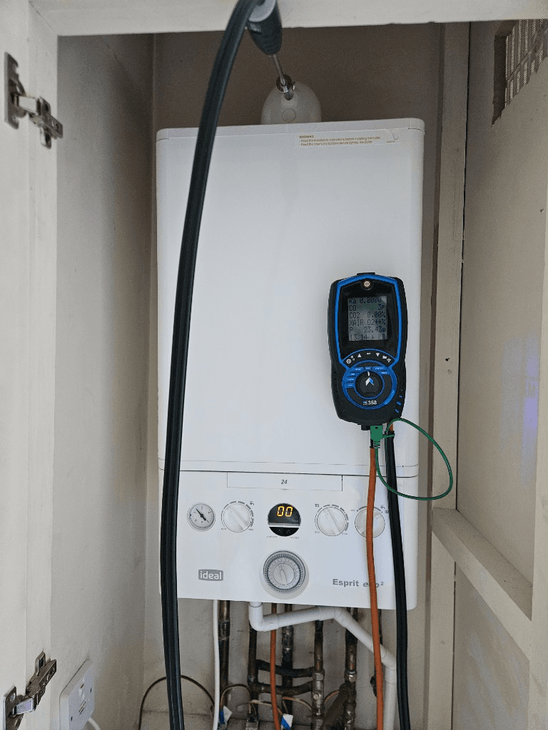 Gas Safe engineer performing flue gas analysis during a boiler service in Torbay