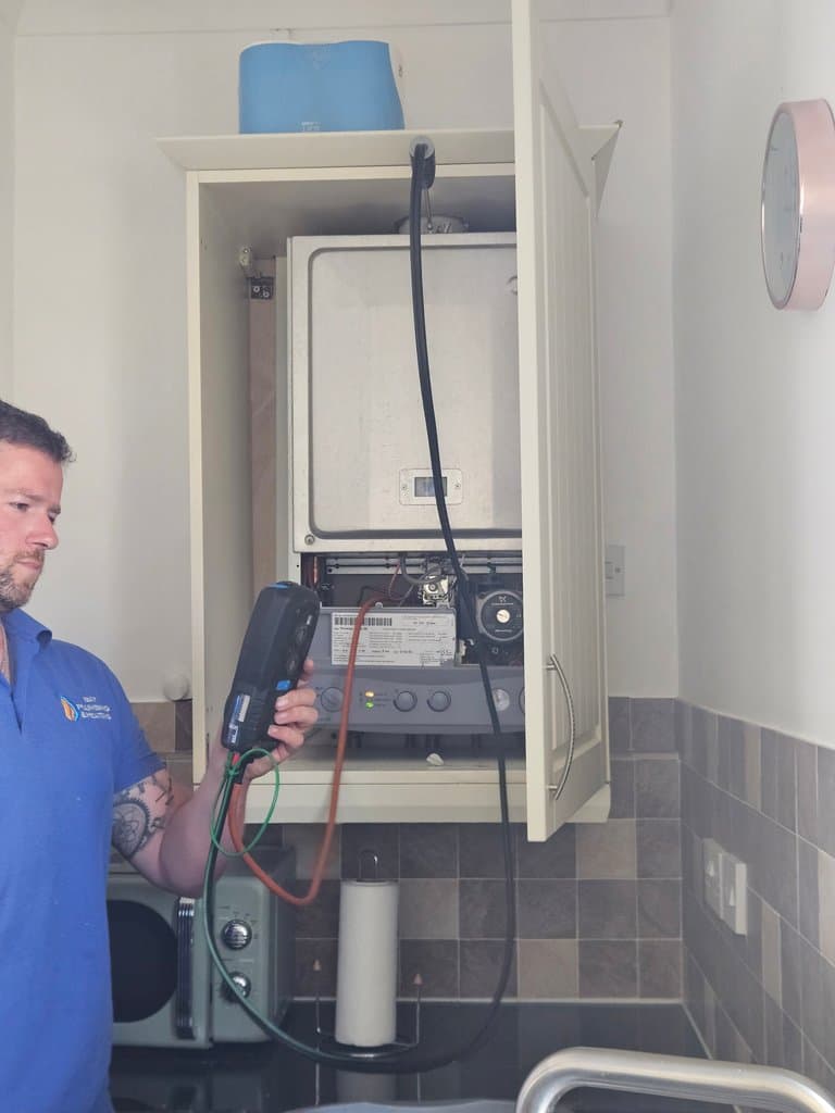 Engineer carrying out testing during an annual Potterton boiler service in Torquay